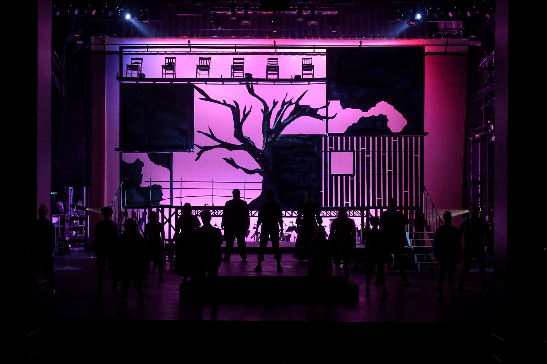 Spring Awakening — company silhouetted against the magenta backdrop