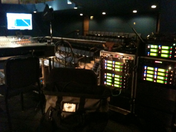 Legally Blonde — FOH console with racks of wireless receivers glowing green