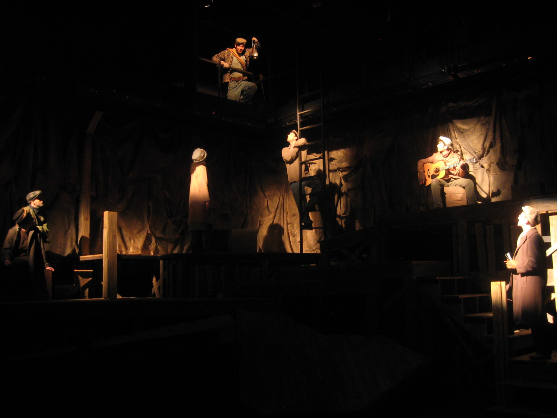 Floyd Collins — the company spread across the levels of the draped cave set in pooled lantern light