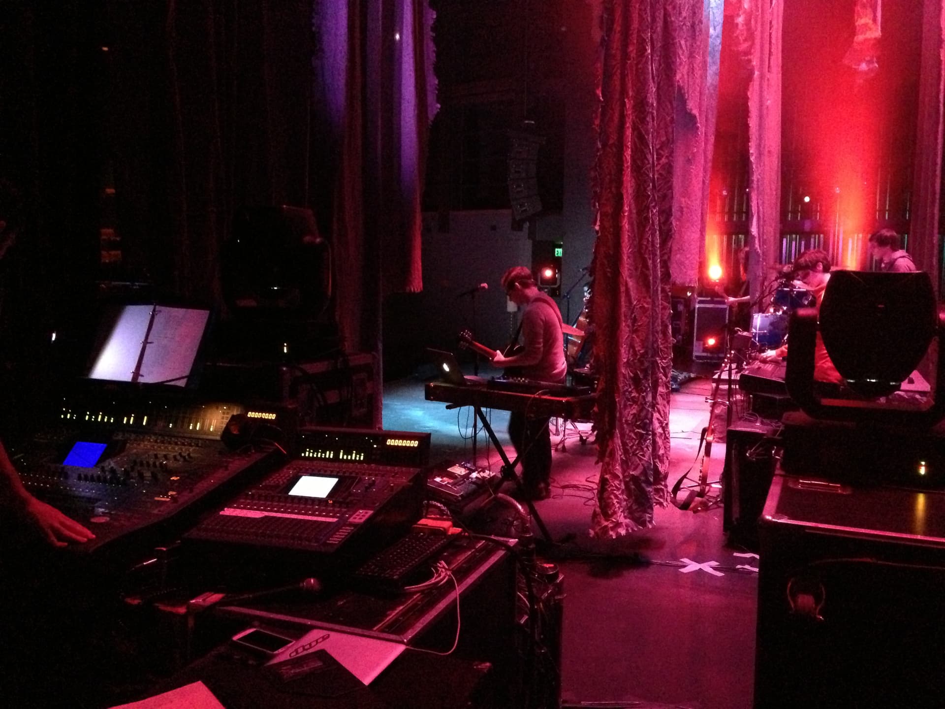 Medea — FOH console foreground with guitarist onstage