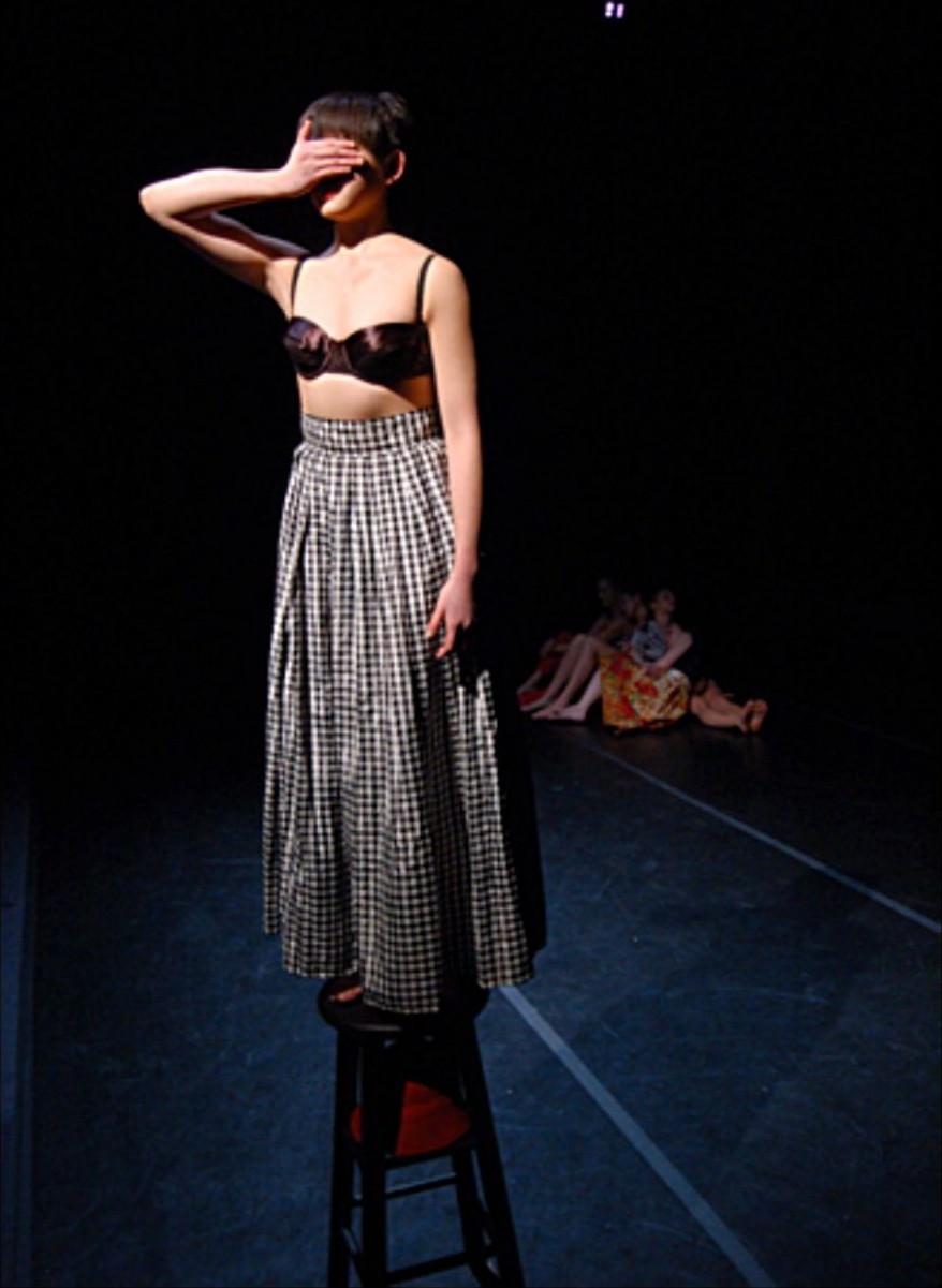 Afterimages — solo dancer shielding her eyes on a stool