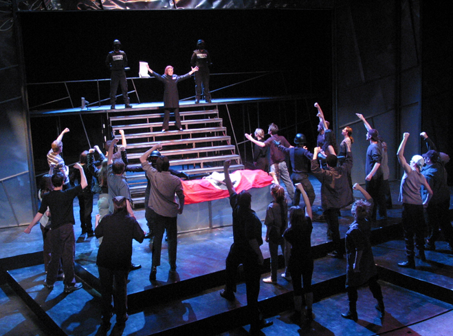 Julius Caesar — company around the red-draped bier on the multi-level set